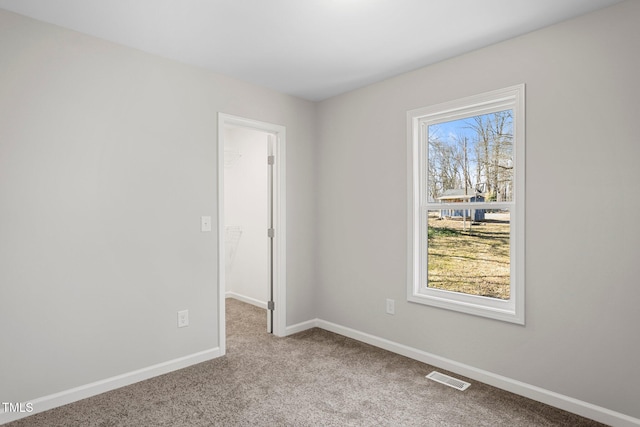 unfurnished room featuring light carpet