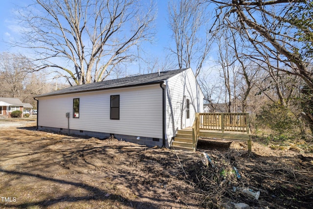 view of side of home featuring a wooden deck