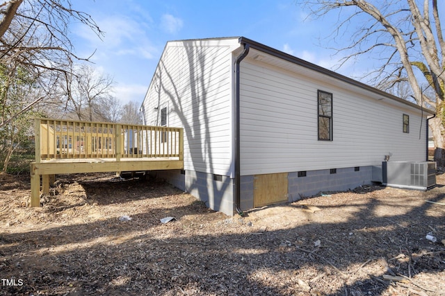 view of side of home featuring a wooden deck and central AC unit