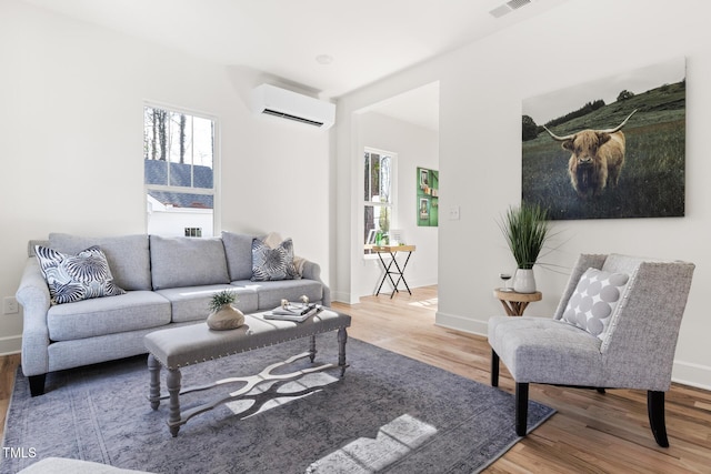 living room with wood-type flooring and a wall mounted AC