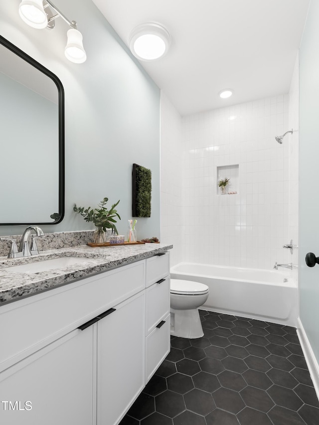 full bathroom featuring vanity, toilet, tiled shower / bath combo, and tile patterned flooring