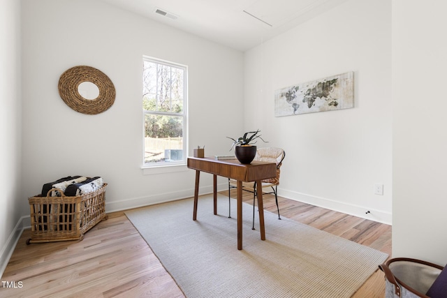 office area with light hardwood / wood-style floors