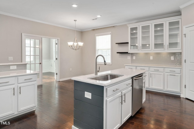 kitchen with stainless steel dishwasher, a center island with sink, and white cabinets