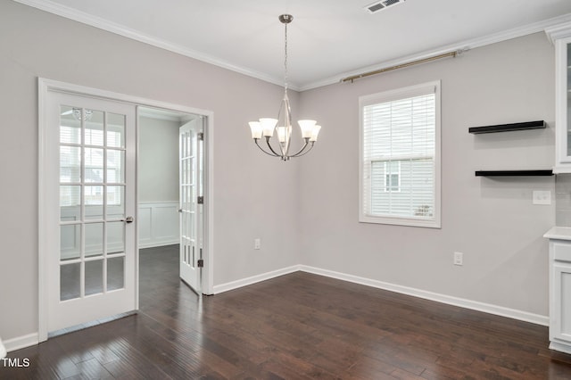 unfurnished dining area with ornamental molding, dark hardwood / wood-style flooring, a chandelier, and plenty of natural light