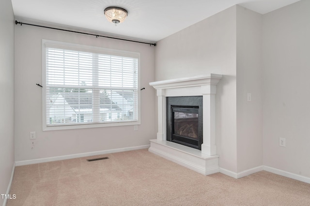 unfurnished living room featuring light carpet