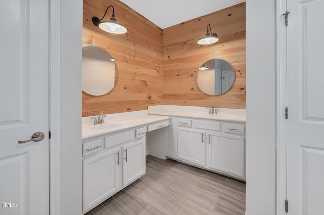 bathroom with vanity and wood walls