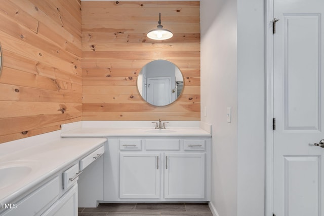 bathroom with vanity and wood walls