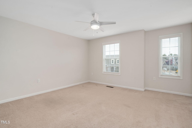 carpeted empty room with ceiling fan