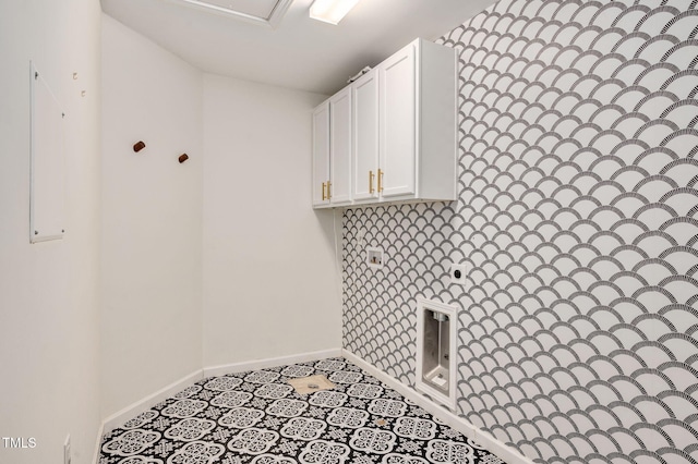 clothes washing area with cabinets, hookup for an electric dryer, and light tile patterned floors