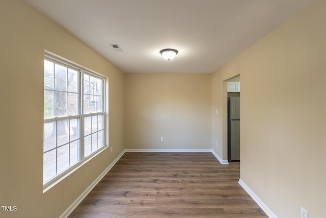 unfurnished room featuring hardwood / wood-style flooring