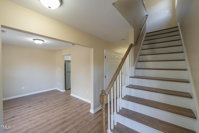 staircase featuring wood-type flooring