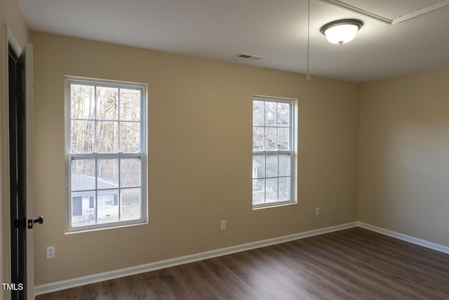 412 N Cooper St, Clayton, NC 27520 - unfurnished room with dark wood finished floors, healthy amount of natural light, baseboards, and attic access
