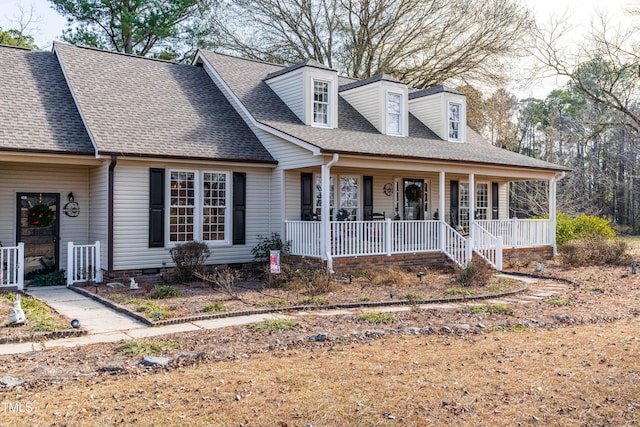 cape cod-style house featuring covered porch