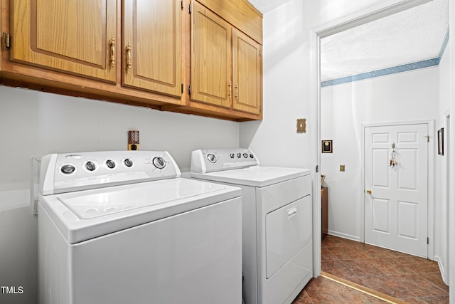 laundry area featuring washing machine and dryer and cabinets