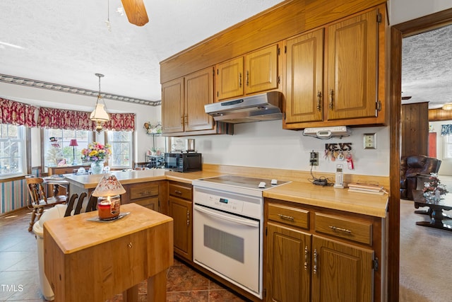 kitchen with wood counters, white range with electric stovetop, decorative light fixtures, ceiling fan, and a textured ceiling