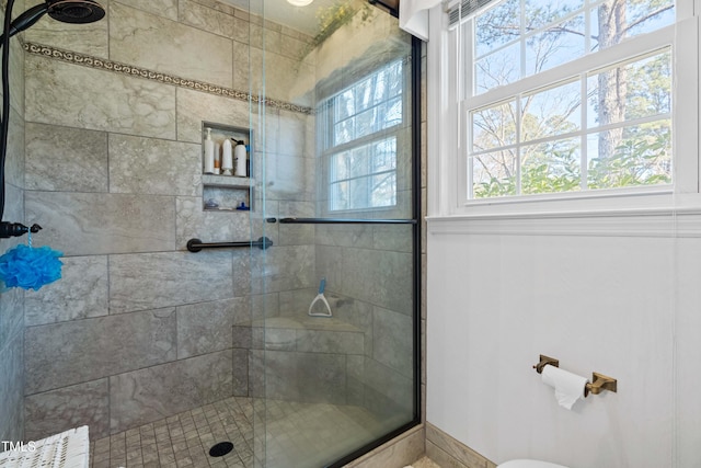 bathroom featuring a shower with shower door