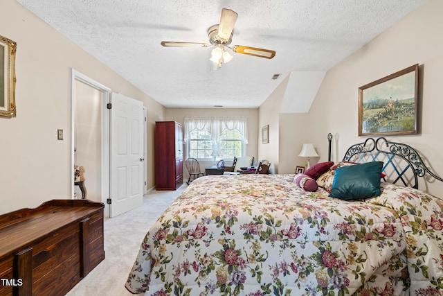 carpeted bedroom with a textured ceiling and ceiling fan