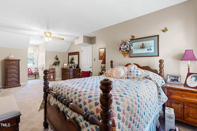 carpeted bedroom with ceiling fan, vaulted ceiling, and a textured ceiling