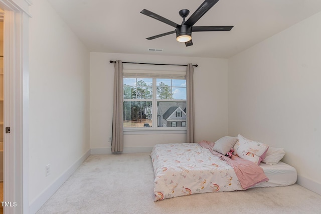 bedroom with ceiling fan and light carpet