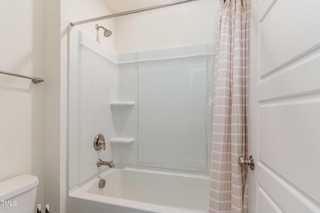 bathroom with shower / bathtub combination with curtain and toilet