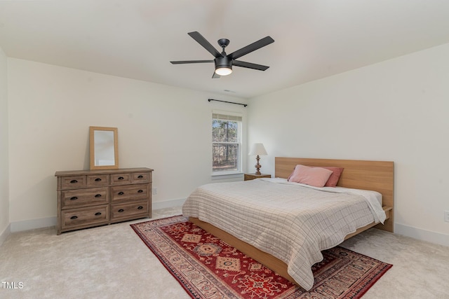 bedroom featuring ceiling fan and light carpet