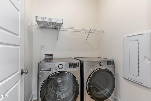 laundry area with independent washer and dryer