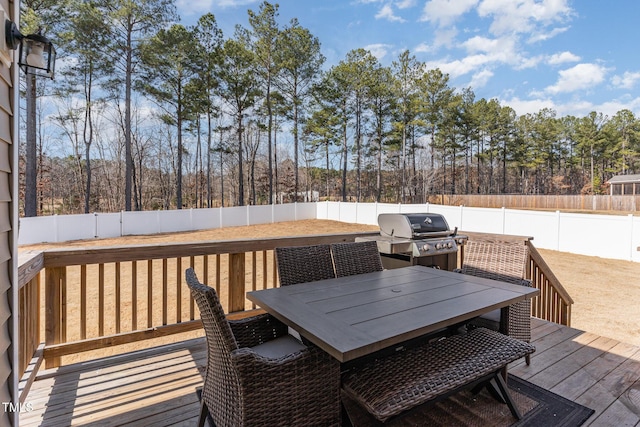 wooden deck featuring a grill