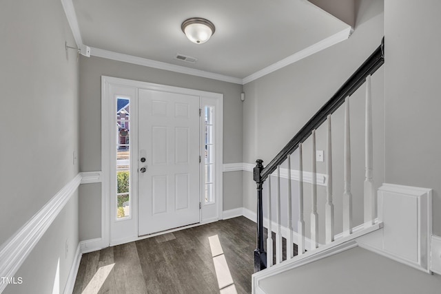 entryway with ornamental molding and dark hardwood / wood-style flooring