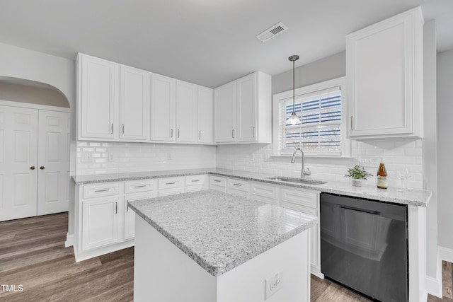 kitchen featuring white cabinetry, sink, decorative light fixtures, and black dishwasher