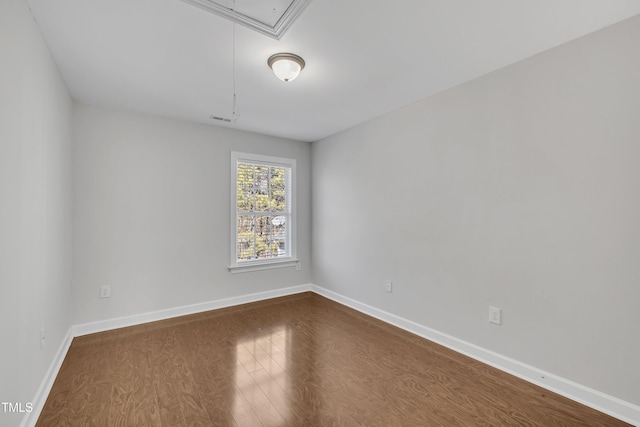 spare room with wood-type flooring