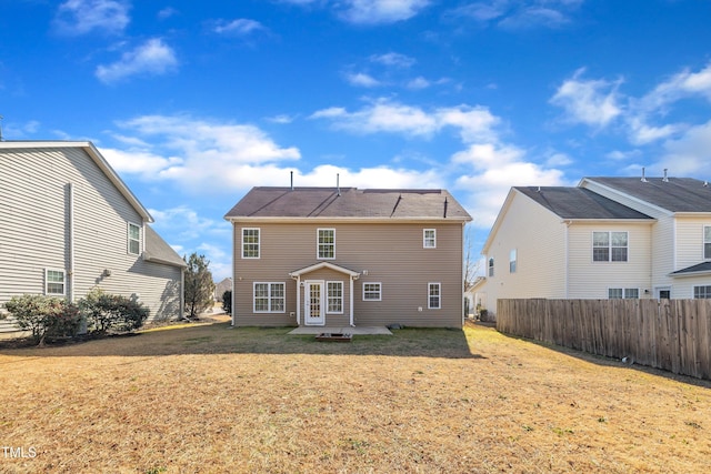 rear view of property with a lawn