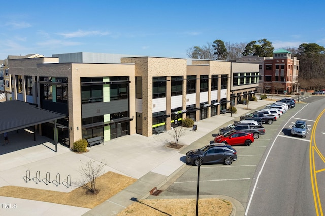 view of building exterior with uncovered parking