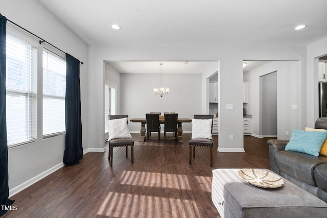 living area with baseboards, recessed lighting, dark wood finished floors, and a notable chandelier