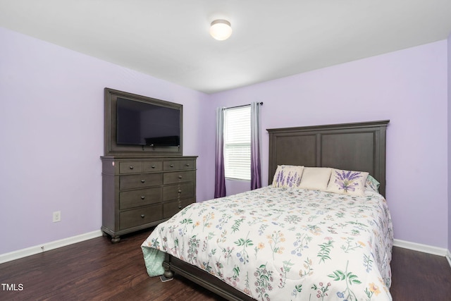 bedroom featuring dark wood finished floors and baseboards