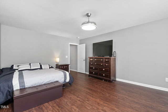 bedroom featuring baseboards and wood finished floors