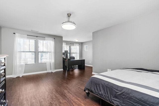 bedroom with baseboards and wood finished floors