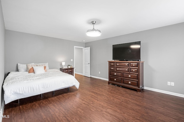 bedroom with baseboards and wood finished floors