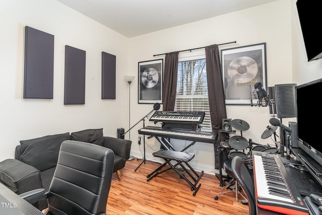 home office with light wood-type flooring and baseboards