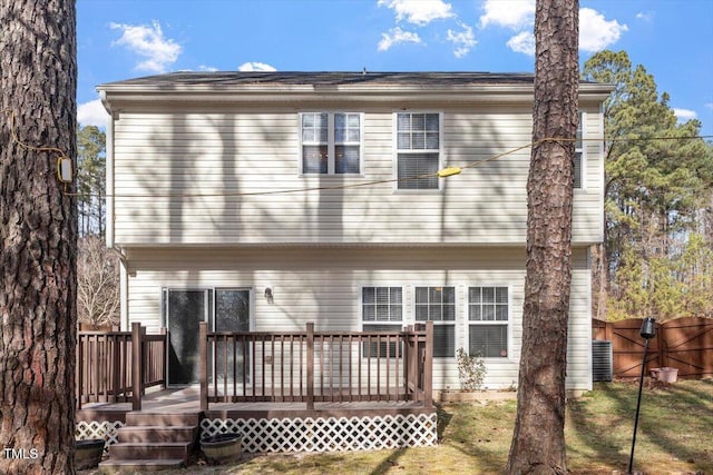 rear view of property featuring a wooden deck and central air condition unit