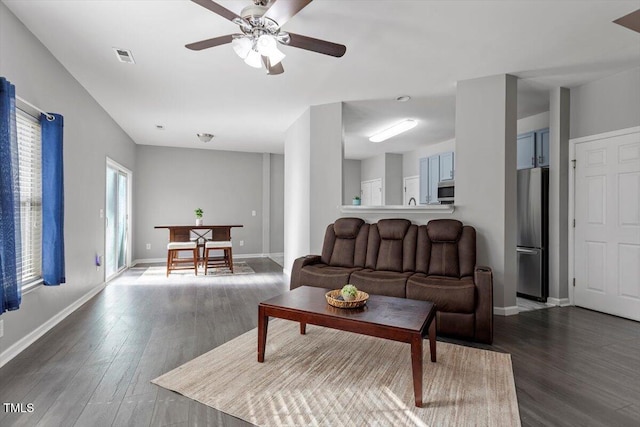 living room featuring wood-type flooring and ceiling fan