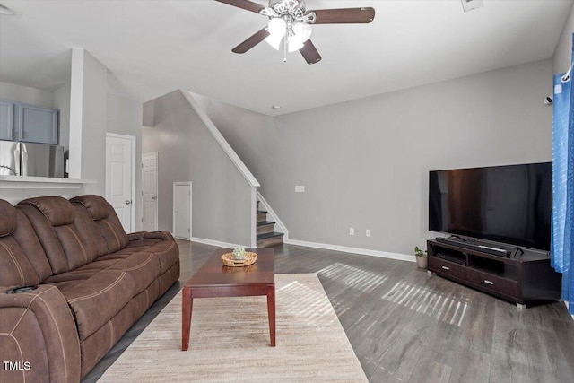 living room featuring hardwood / wood-style floors and ceiling fan