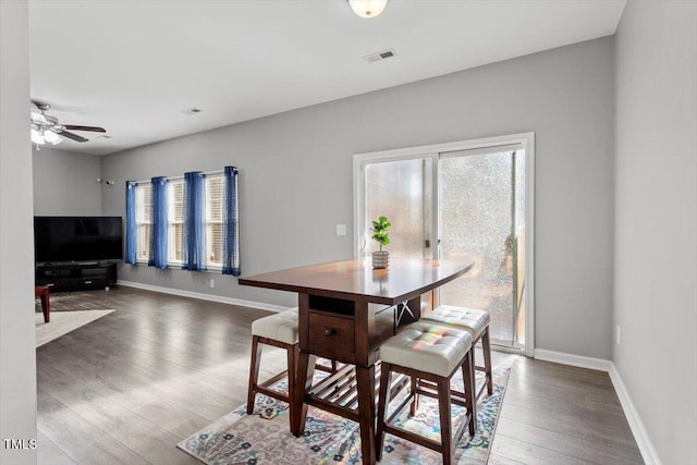 dining room with ceiling fan and dark hardwood / wood-style floors