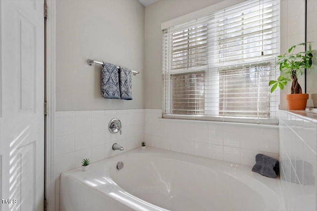 bathroom with a tub to relax in