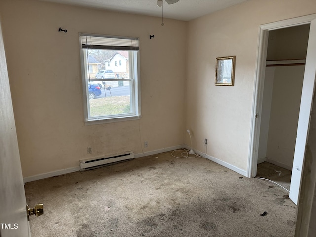 unfurnished bedroom with a closet, light carpet, and a baseboard heating unit