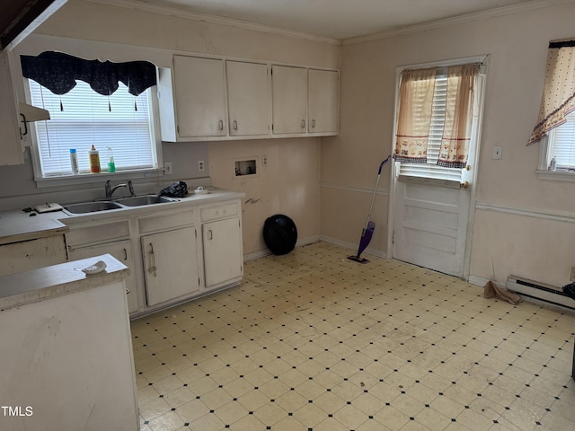 kitchen with sink, crown molding, a wealth of natural light, and white cabinets