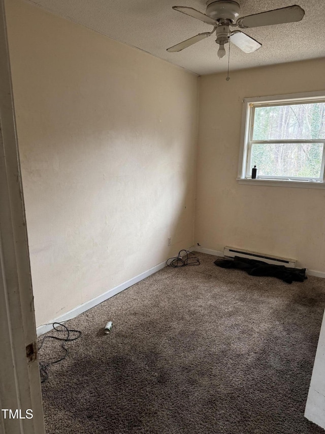 carpeted empty room with ceiling fan, a baseboard radiator, and a textured ceiling