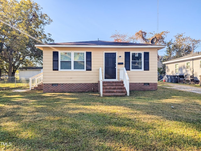 bungalow-style house with a front yard