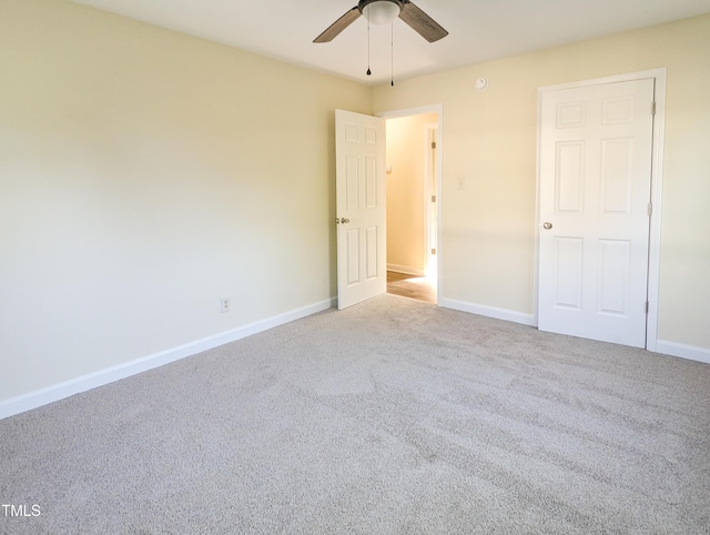 unfurnished bedroom with light colored carpet and ceiling fan