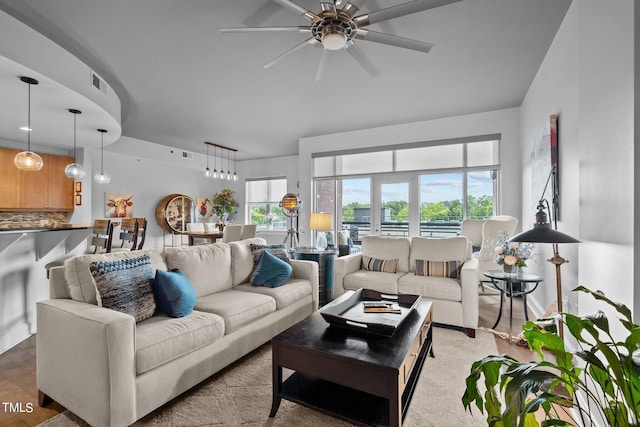 living room with ceiling fan and light wood-type flooring