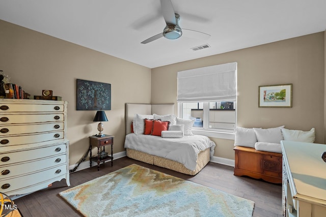 bedroom featuring visible vents, baseboards, and dark wood-style floors